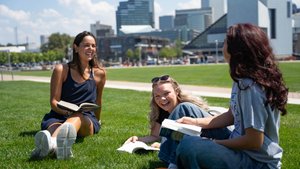 Students Reading Textbooks on Grass