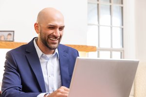 Smiling Man Blue Suit Laptop Screen