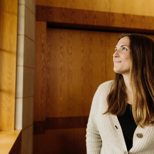 Woman Beige Cardigan Looking Out Window